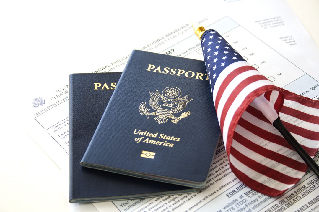 U.S. passports and an American flag on immigration paperwork