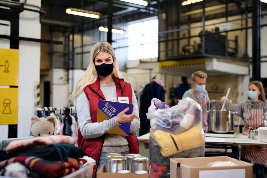 Volunteer holding a clipboard at a community aid center
